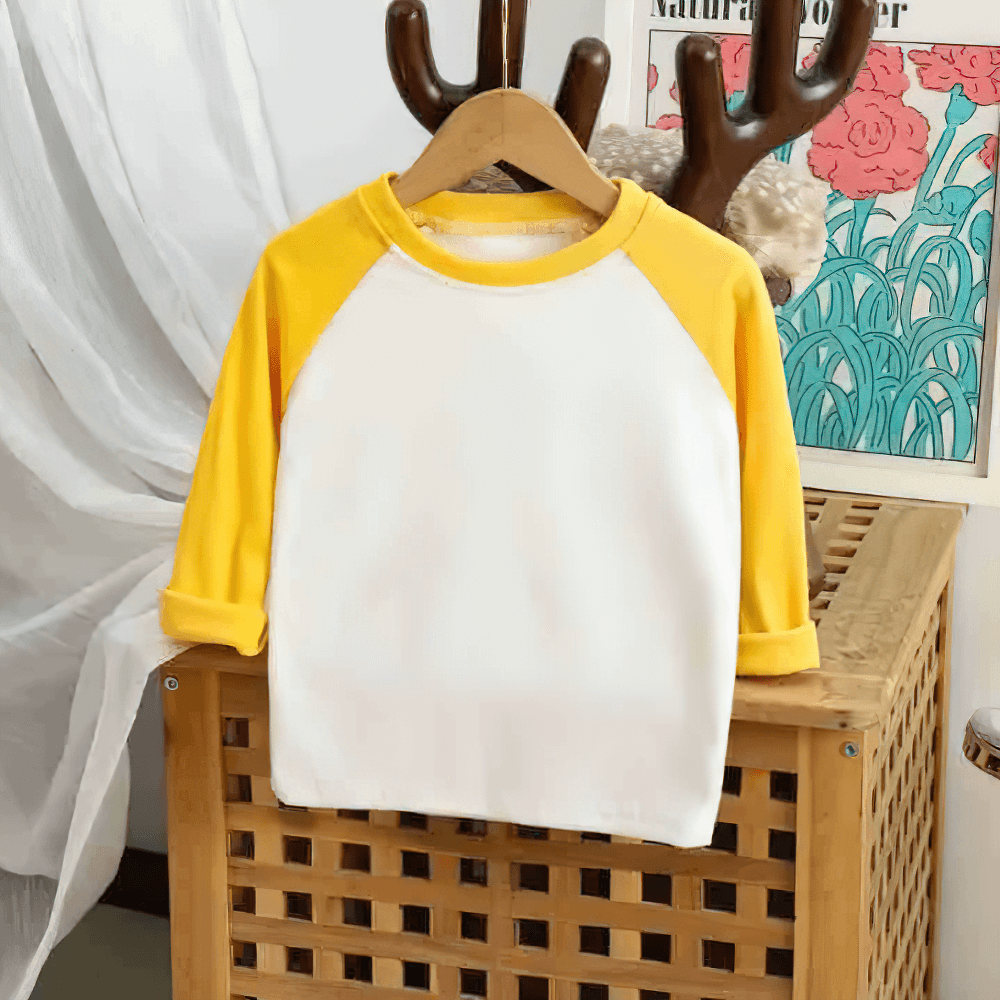 Adorable yellow and white kids' top with raglan sleeves and round neck, perfect for playful days. Model SF3099 displayed on a hanger.
